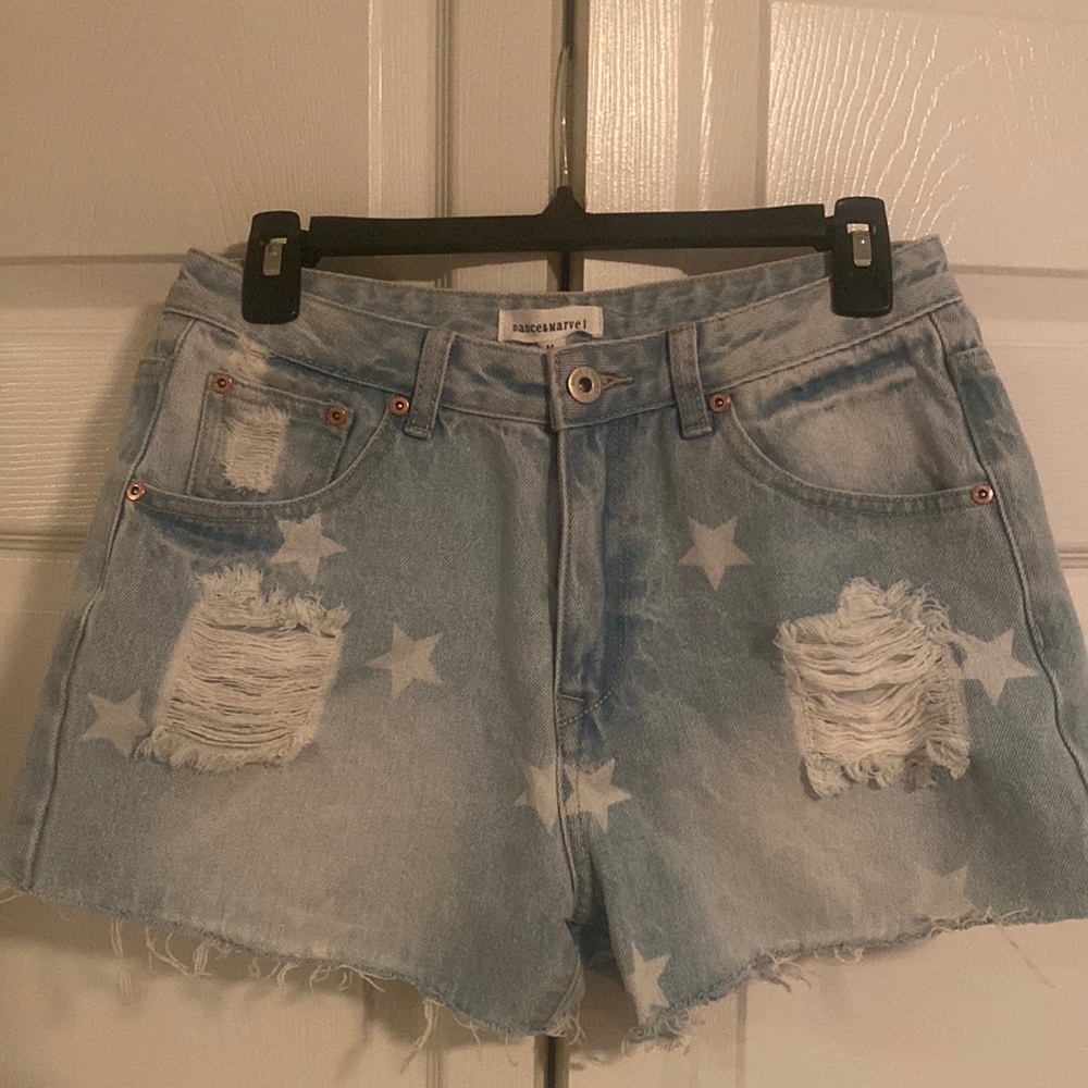 Light wash cut off Jean shorts with stars. NWT
